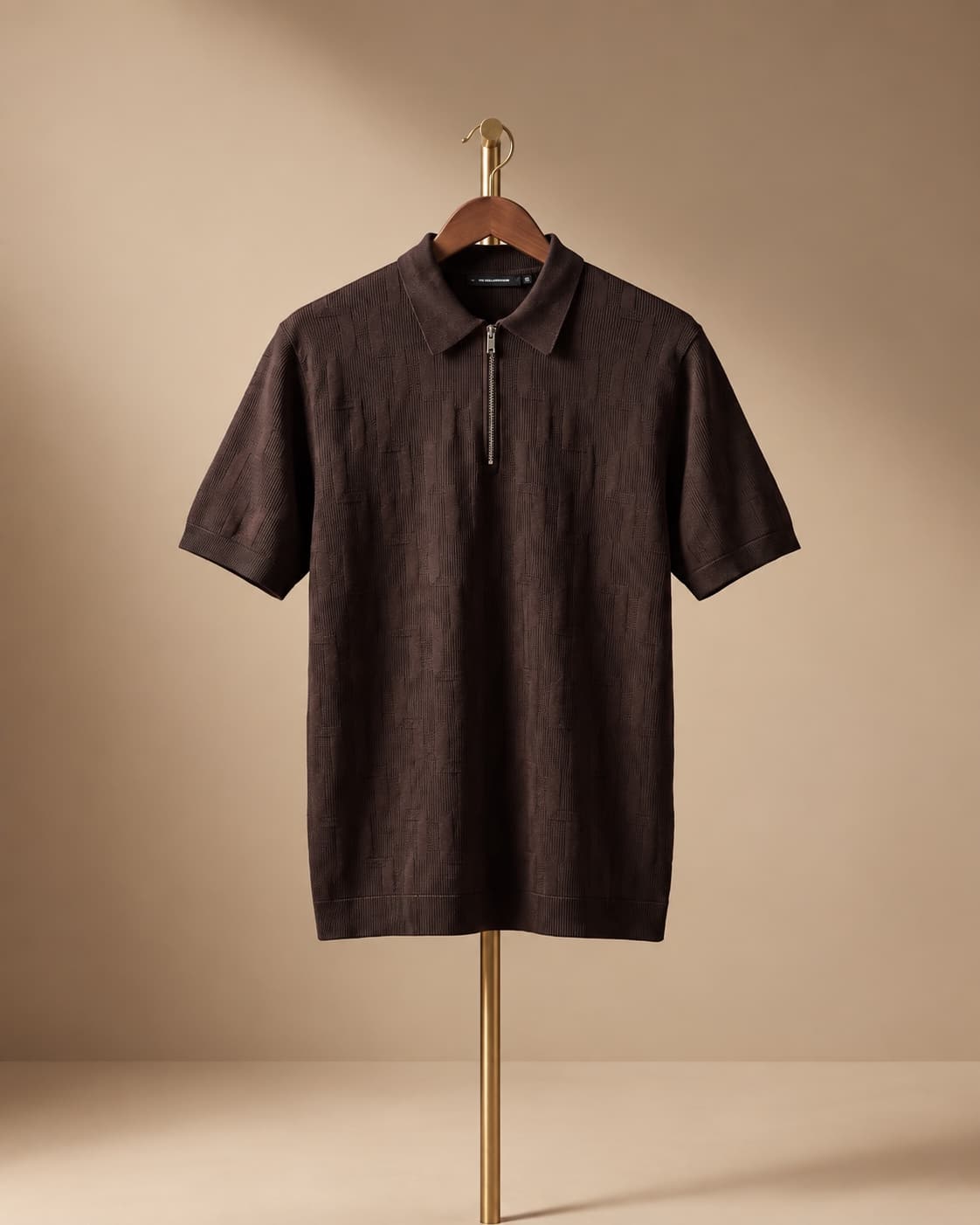Brown knit zip polo on a hanger